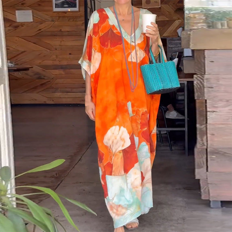Loose, long dress with floral pattern and half-length sleeves
